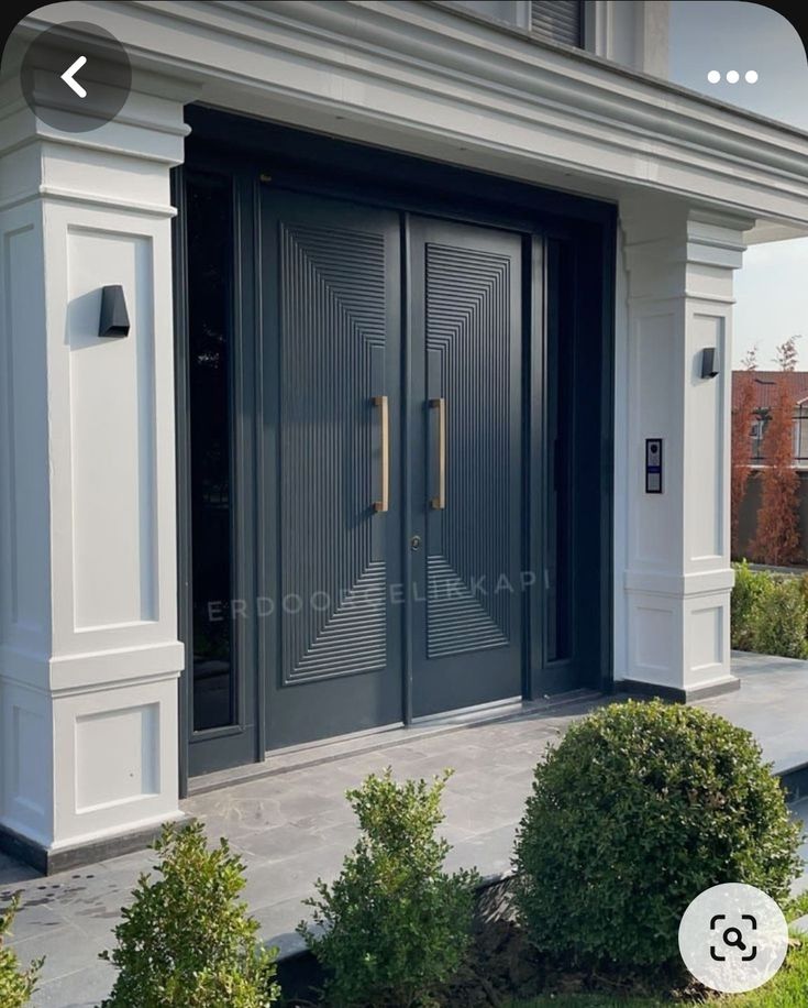 the front entrance to a house with two double doors