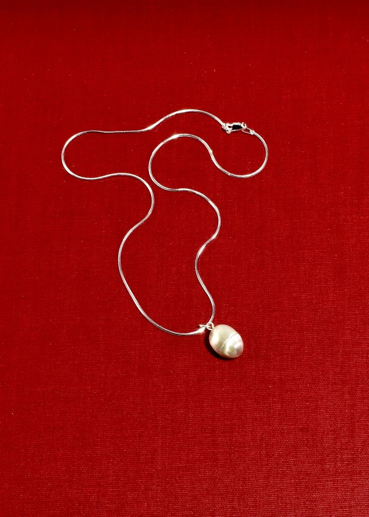 Sterling egg pendant necklace with a screw mechanism and hollow center to store a talisman. It is designed for the wearer to carry around a special, personal object to hold close to your heart — akin to a locket. Contains petite freshwater seed pearls. Each piece is hand carved, cast, and finished in New York by Owen Dunton of Dunton Ellerkamp. Available in a 16" solid snake chain or an 18" delicate oval chain. Material: Sterling silver. We recommend storing in a dry place and periodic polishing Solid Snake, Seed Pearl, Snake Chain, Sale Design, Ring Necklace, Locket, Jewelry Art, Ring Earrings, Necklaces Bracelets