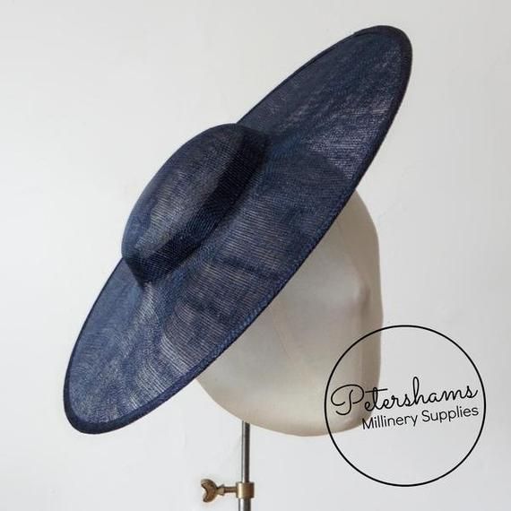 This french navy cartwheel hat base is a classic shape that has sprung into popularity in the past year. Made from 2 layers of stiffened sinamay, these cartwheels are ready to trim and are fitted with a petersham ribbon on the inside crown edge. Simply add a comb or headband to secure to the head.Hat base measures:Width: 35.5cm (14 inches)Crown Width: 13.5cm (5.3 inches)Crown Height: Approximately 3.5cm (1.7 inches)For even more millinery supplies you can find us here:www.etsy.com/shop/Petersham Fitted Hat With Round Crown For Kentucky Derby, Adjustable Flat Brim Top Hat For Church, Spring Navy Adjustable Hats, Adjustable Curved Brim Boater Hat For Royal Ascot, Adjustable Flat Brim Hat For Royal Ascot, Adjustable Hat With Round Crown For Summer, High Crown Adjustable Boater Hat For Races, Classic Wide Brim Adjustable Fascinator, Classic Adjustable Wide Brim Fascinator