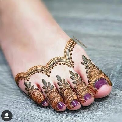 the feet are decorated with henna designs