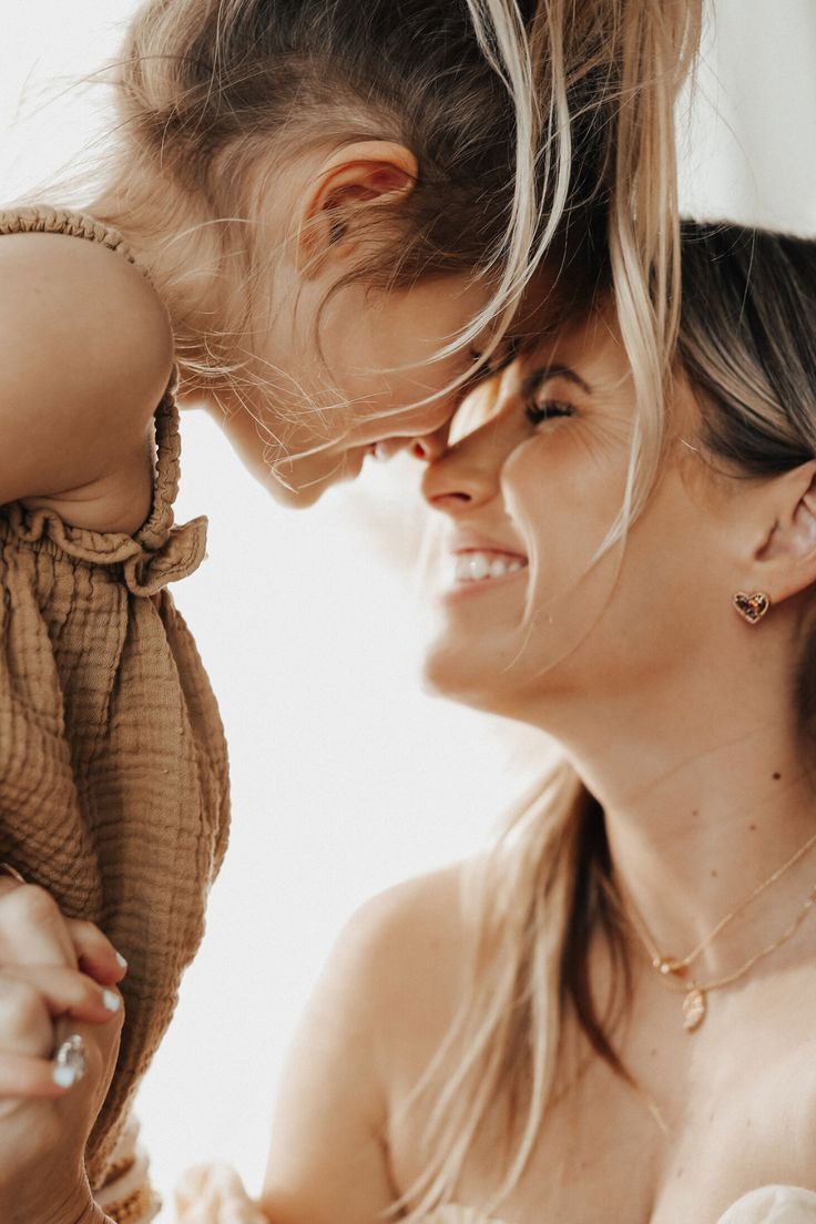 a woman holding a baby up to her face