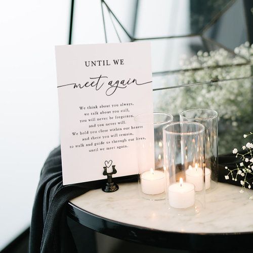 a table with candles and a sign on it that says, until we meet again