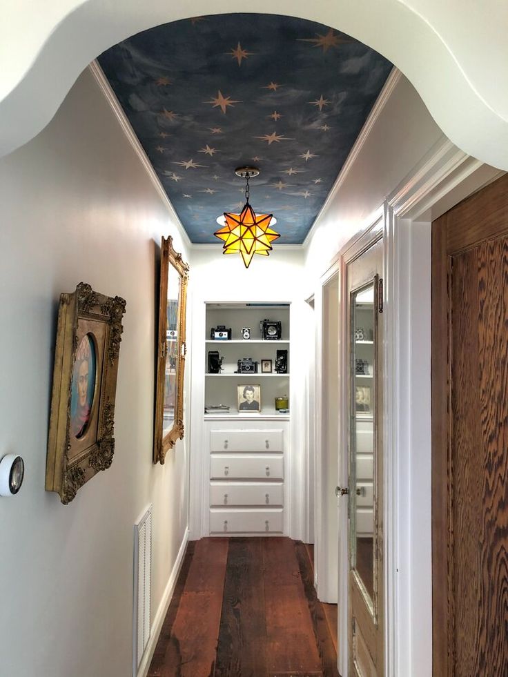 the hallway is decorated in blue and white with stars painted on the ceiling above it