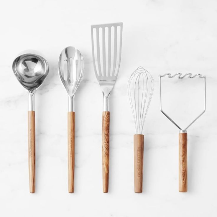 five kitchen utensils lined up next to each other