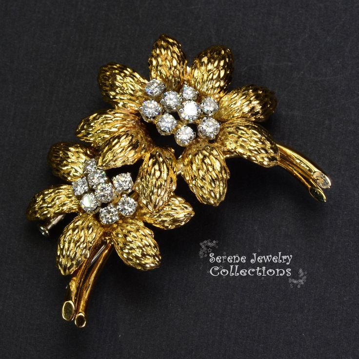 This yellow 18k gold Vintage GUBELIN Diamond Flower Brooch is simply stunning and rare! The two flowers each have 8 to 9 sparkly white diamond rounds in the middle totaling 1.78 carats that bring the brooch to life. Total Weight: 23.68 grams Size: 2 inches tall, 1.7 inch wide Precious Metal: 18k yellow gold Precious stones: -White Round Diamonds Fine Jewelry Diamond Brooch In Gold, Exquisite Diamond Brooches In Yellow Gold, Exquisite Yellow Gold Diamond Brooches, Diamond Yellow Gold Brooch For Anniversary, Diamond Flower Brooch For Formal Occasions, Anniversary Diamond Brooch In Yellow Gold, Elegant Gold Brooches With Diamond Accents, Elegant Yellow Gold Diamond Brooches, Elegant Diamond Flower Brooch