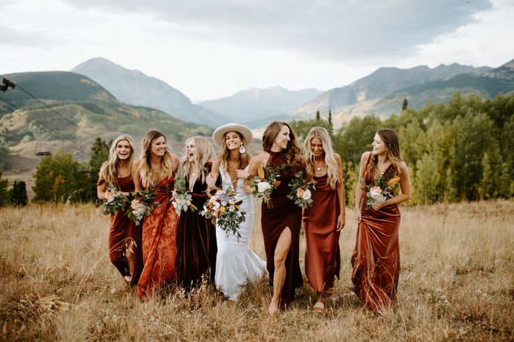 a group of women standing next to each other in a field