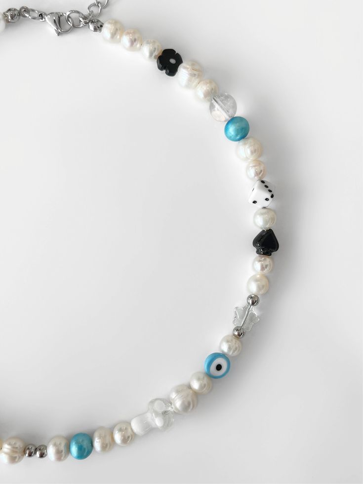 Oh, it's love. Introducing the 'CHALAMET' necklace AKA your jewelry collection's soulmate. Featuring genuine freshwater pearls strung alongside the most precious of charms, this one-of-a-kind piece will easily become a staple in your jewelry rotation. NOTE: Due to the nature of this item, some beads may vary. Made with freshwater pearls and glass, ceramic, and handmade beads. Waterproof and rust-free. Available in lengths 14", 15", 16", 18", 20". All lengths include a 2" extension chain. Handmad Handmade White Pearl Charm Necklaces, Gift Pearl Charm Necklace With Round Beads, White Charm Necklace With Pearl And Round Beads, White Pearl Charm Necklace With Round Beads, White Beaded Pearl Charm Necklaces, Spiritual Beaded Necklace With Pearl Charm As Gift, Pearl Beaded Charm Necklace Gift, Pearl Beaded Charm Necklaces As Gift, Pearl Beaded Charm Necklace As A Gift