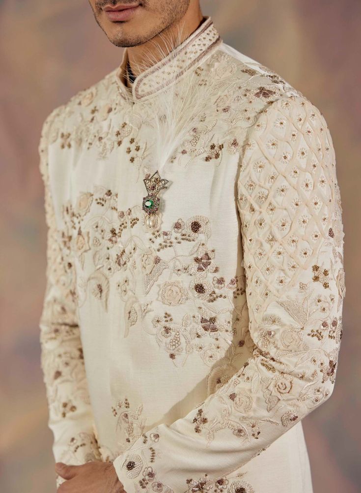 Editor's Note Featuring Dirty Ivory Hand Embroidered Sherwani With All Over Tone-on-tone Applique Flowers. Paired With Chikankari Dupatta, Matching Pintuck Kurta And Churidar Fabric: Linen Silk Color: Ivory Component: Sherwani, Kurta, Churidar, Stole Care: Dry Clean Only About the Designer After establishing himself as the leading couturier in the industry of menswear, Jatin Malik went on to explore luxury footwear. You can order online these amazingly designed handmade shoes that are being offe Jatin Malik, Embroidered Sherwani, Applique Flowers, Indian Wedding Outfits, Kurta Designs, Sherwani, Churidar, Bridal Jewelry Sets, Floral Motifs