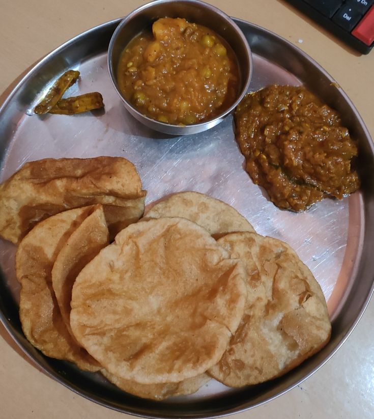 a metal plate topped with different types of food