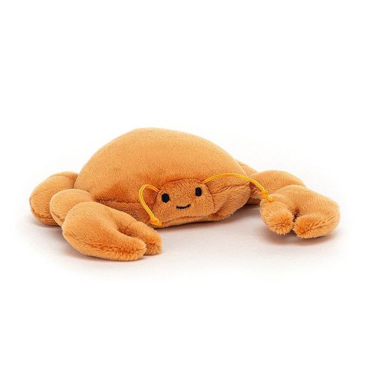 a stuffed animal that is laying down on the ground