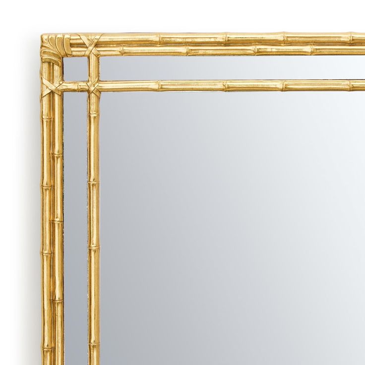 a mirror that is made out of wood and has a bamboo frame on the front