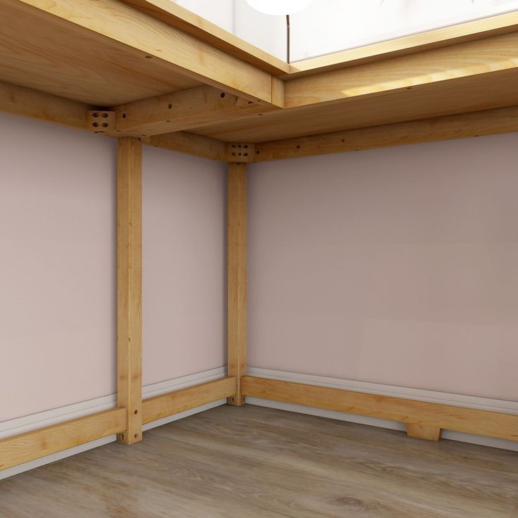 an empty room with pink walls and wooden beams