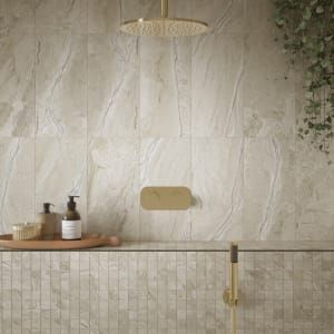 a bathroom with white marble tiles on the wall