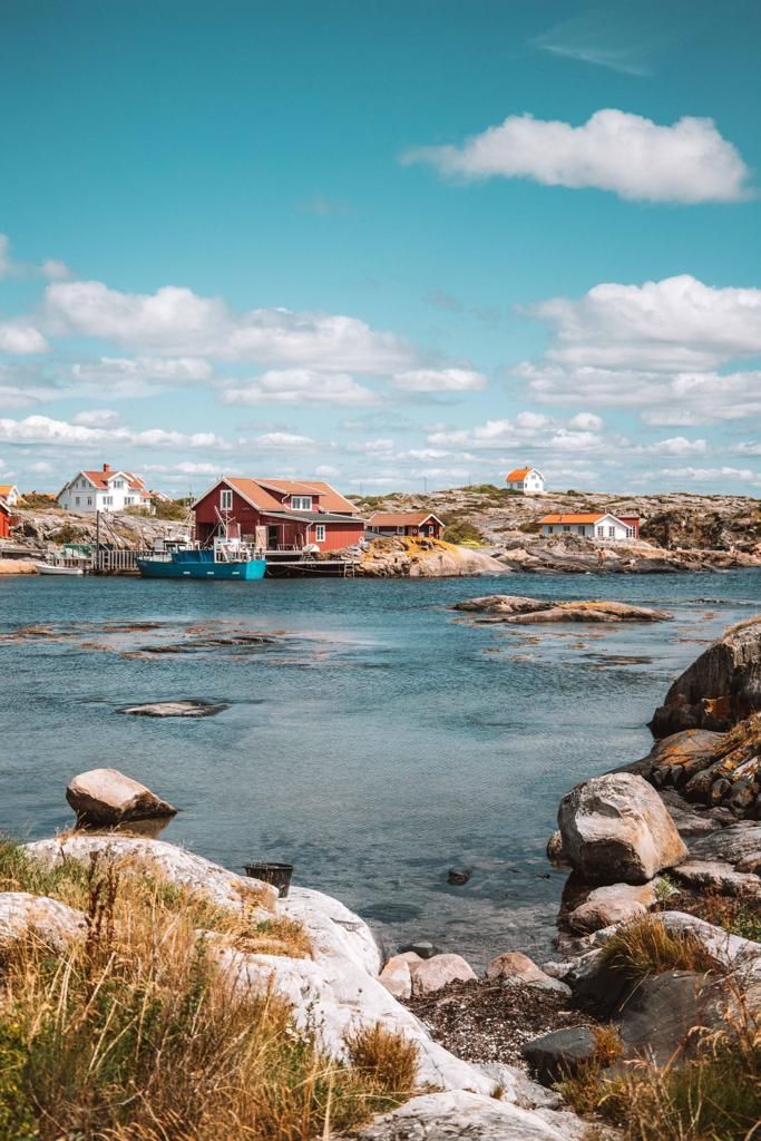 a body of water surrounded by rocks and houses