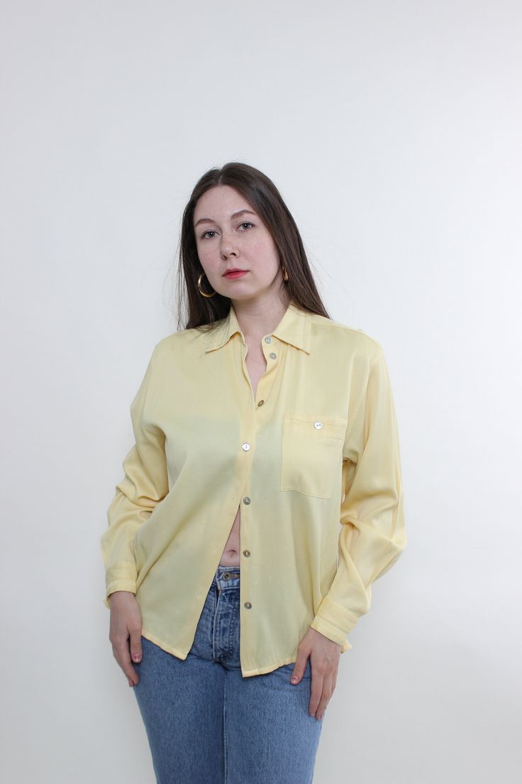 Hi! This is vintage from 90s formal blouse in yellow color with long sleeves. This vintage yellow button up blouse made of synthetic material - POLYESTER and VISCOSE. Model on the photo is 170 cm tall and is wearing a LARGE size long sleeve casual blouse. But, be careful, this is a vintage size, it is better to check the measurements below in the product description. Sleeves - 45cm/ 17.71inch; Width - 53cm / 20.86inch;  Length - 63cm / 24.8inch. All measurements are taken seam to seam while lyin Casual Long Sleeve Yellow Blouse, Casual Yellow Long Sleeve Blouse, Elegant Yellow Long Sleeve Shirt, Elegant Long Sleeve Yellow Shirt, Yellow Formal Shirt For Spring, Formal Yellow Shirt For Spring, Spring Formal Yellow Shirt, Spring Yellow Formal Shirt, Classic Yellow Button-up Tops