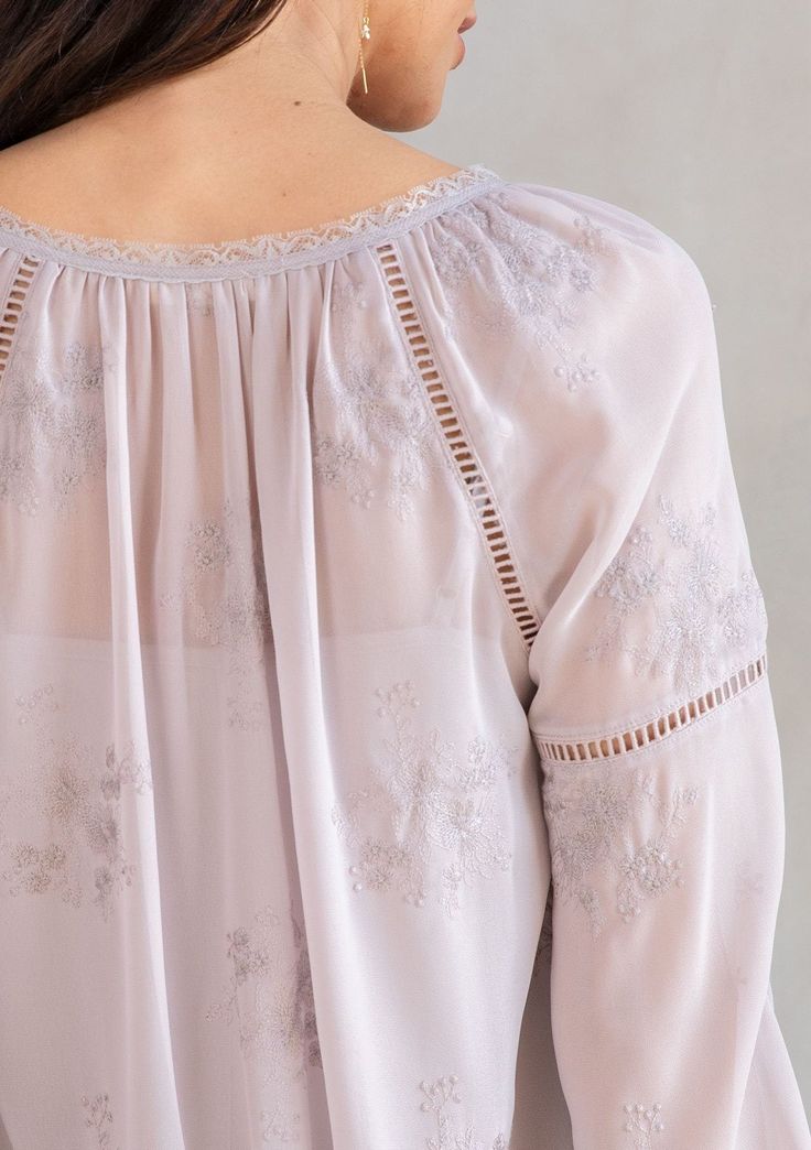 With a classic bohemian silhouette, this dreamy peasant top will be a timeless addition to your closet. Featuring delicate floral embroidery throughout, voluminous long sleeves with lattice trim, and a split v-neckline with tassel ties. We love to style this effortless blouse tucked into trousers or jeans. FINAL SALE Embroidered chiffon Relaxed fit Long voluminous sleeve Elastic wrist cuff Lace-trimmed neckline Split v-neckline with tassel ties Lattice trim throughout Sheer Removable lining Peas Bohemian Long Sleeve Blouse For Gatherings, Long Sleeve Bohemian Tops For Gatherings, Elegant Spring Peasant Top With Blouson Sleeves, Long Sleeve Peasant Top For Summer Gatherings, Flowy Peasant Top With Blouson Lantern Sleeves, Elegant Peasant Top With Blouson Sleeves For Spring, Feminine Long Sleeve Peasant Top For Fall, Long Sleeve Bohemian Peasant Top For Daywear, Bohemian Long Sleeve Peasant Top For Daywear