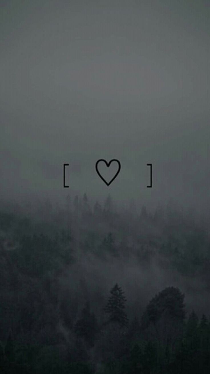 the word i love is written in black on a foggy background with trees and mountains