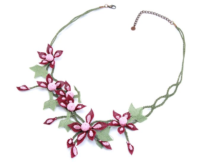 With its striking form and breathtaking color, the exquisitely detailed Winter's Rose Necklace offers a bold, eye-catching piece of Oya artistry that you can wear all year long. Product Description Necklace Details Length: 24.5" Materials: 100% Art Silk, Brass Alloy Every piece of Oya jewelry is 100% handmade by a dedicated artisan. Small variations in color and pattern may occur. Instructions for Care Our pieces are designed to last a lifetime without any special maintenance. When life has othe Flower-shaped Rose Design Necklace For Party, Elegant Handmade Pink Flower Necklace, Elegant Rose Red Necklace With Rose Design, Handmade Rose Flower Jewelry, Handmade Pink Flower-shaped Necklace, Bohemian Jewelry With Rose Design For Gift, Bohemian Jewelry With Rose Design As Gift, Bohemian Rose Design Jewelry For Gifts, Elegant Handmade Green Flower Necklace