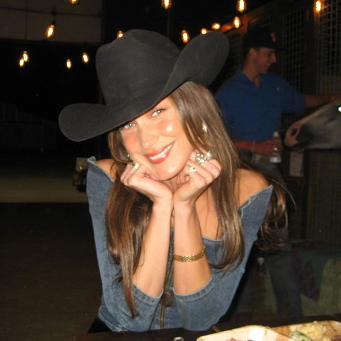 a woman wearing a cowboy hat sitting at a table