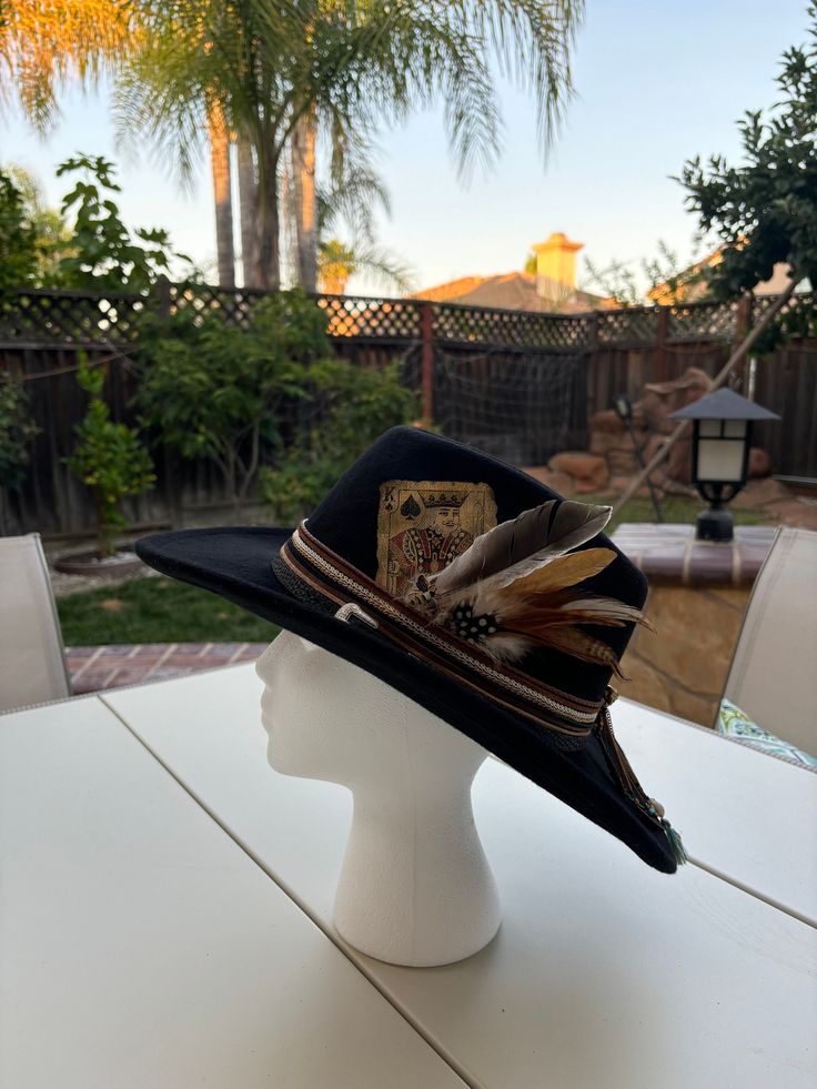 Our unique one of a kind hats are made with love and customized based on a vintage western aesthetic <3 Each piece is a one of one design  Why Choose Us? We take pride in crafting hats that not only look good but also feel great to wear. Each piece is carefully made with attention to detail, ensuring you receive a product that meets the highest standards of quality. When you purchase from us, you're not just buying a hat--you're investing in a statement piece that reflects your individuality and Black Felt Hat For Western-themed Events, Black High Crown Felt Hat For Western-themed Events, Black Felt Hat With High Crown For Western-themed Events, Western Style Black Top Hat For Western-themed Events, Vintage Black Top Hat For Western-themed Events, Western Black Hat Band For Western-themed Events, Western High Crown Felt Hat For Western-themed Events, Western Felt Hat With High Crown For Western-themed Events, Western Black Fedora For Western-themed Events