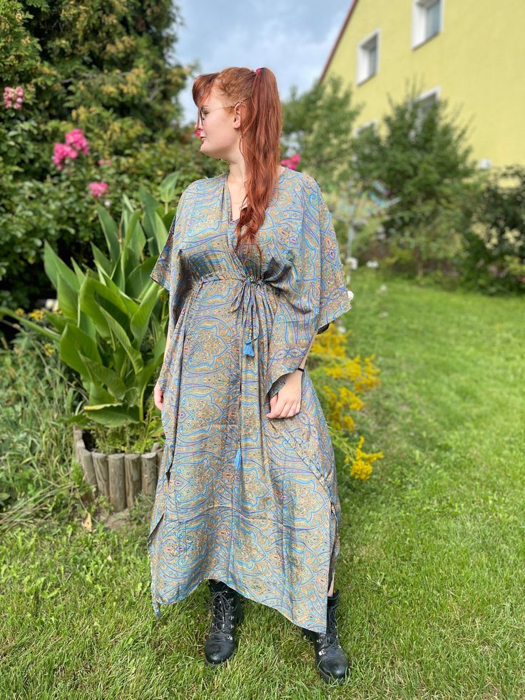 Our handmade  kaftan is made of high quality soft Indian silk blend printed with beautiful abstract and floral print. This garment is perfect for any type of occasion. From day on the beach, to an evening dinner or even a cocktail party, Thanks to its strap it is possible to adapt it to any type of body and size. It can be worn  unfastened  as a tunic or by tightening the belt it takes shape on your body becoming a stunning dress.  The best choice to impress, you'll look divinely beautiful in this boho chic dress. A must have for every bohemian queen. Length 51 inches 70% Silk 30% Viscose ONE SIZE FITS ALL! Bohemian Printed Kaftan With Kimono Sleeves, Bohemian Maxi Kaftan With Floral Print, Bohemian Printed Dresses With Kimono Sleeves, Bohemian Printed Dress With Kimono Sleeves, Bohemian Kaftan With Boho Print And Kimono Sleeves, Bohemian Printed Maxi Length Kimono, Bohemian Free Size Kaftan With Boho Print, Bohemian Dress With Printed Kimono Sleeves, Bohemian Green Kaftan With Kimono Sleeves