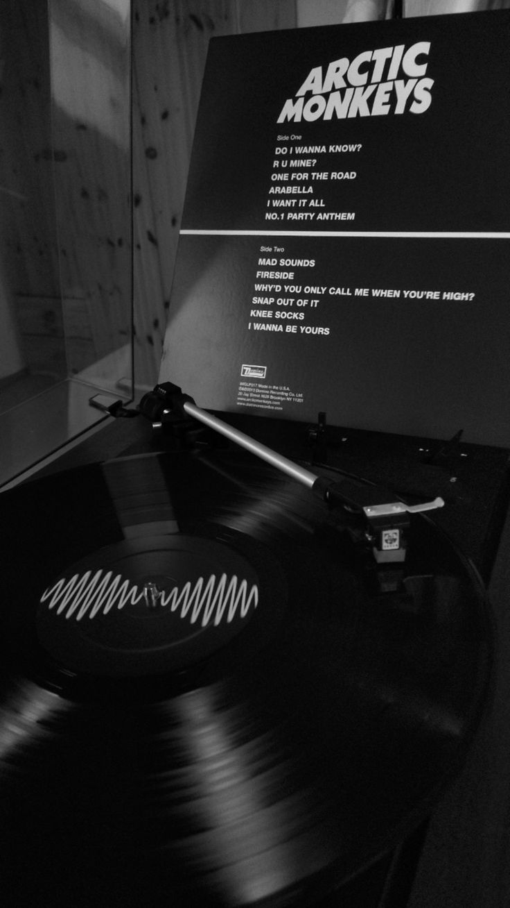 an old record player with the arctic monkeys logo on it's back cover is shown in black and white