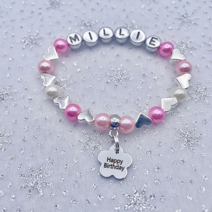 Unique beautiful personalised glass pearl bead bracelet complete with silver hearts, silver flowers or diamante sparkles in between beads plus a HAPPY BIRTHDAY CHARM, PLAIN LITTLE HEART or STAR Charm or an INITIAL charm in the colour/colours of your choice at a SUPERB PRICE (limited time only).  MANY OTHER FAMILY MEMBERS, CHARMS & WEDDING ATTENDANT Bracelets available in my shop. All bracelets are designed and made to order with the charm, name & colour of your choice, fantastic gift for your special friend. Ideal gift for Birthday. All bracelets are sent out in a pretty organza gift bag with an attached blank heart shaped tag for you to write on. You can choose to have a free printed gift message as you go through payment if you'd prefer. The bracelets are made with top quality super stro Birthday Charm Bracelet, Pearl Bead Bracelet, Heart Gift Tags, Sparkly Ring, Happy Birthday Gifts, Personalized Glass, Name Bracelet, Gift Message, Heart Gifts