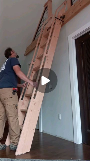 a man standing next to a wooden stair case