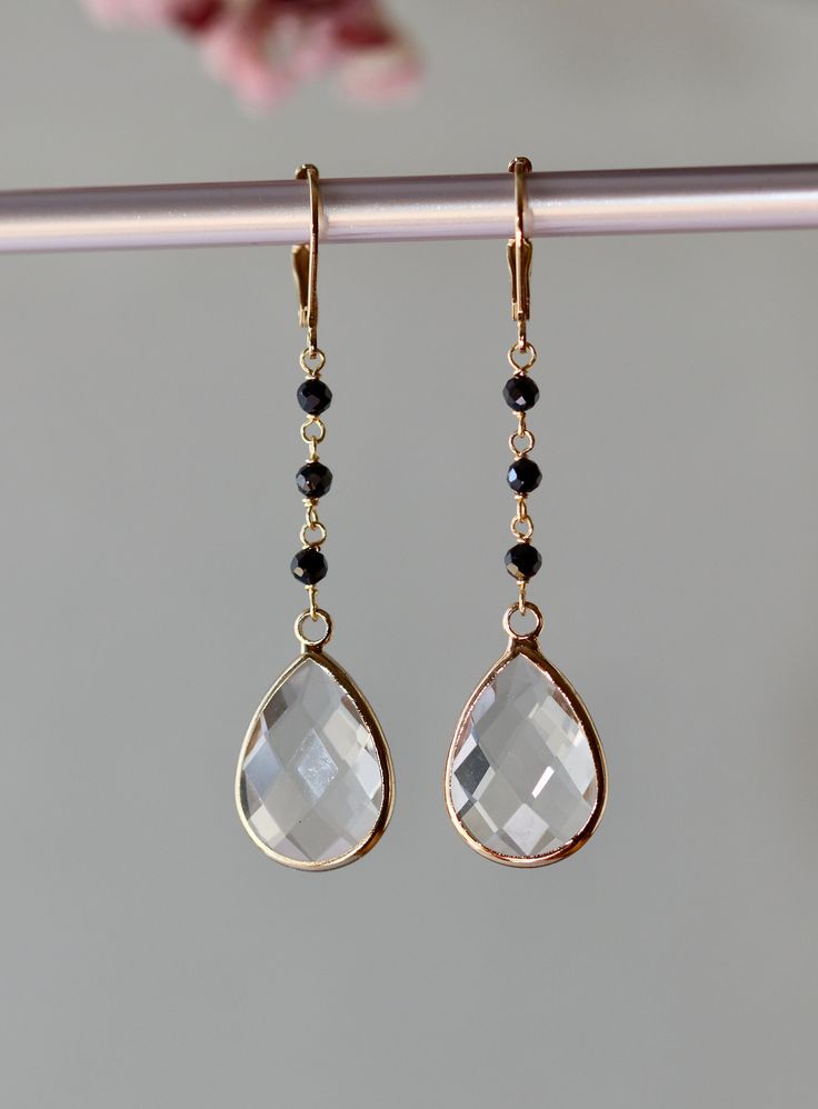 Elegant Earrings with    Faceted Clear Crystal Pear Drops 17 x 12 mm. Faceted small Black Onyx beads 2.5mm.   Gold plated Lever back Ear clasp. The total length is 2.25 inches or 57 mm * *.* * * * * * * * * * * * * * * * * * * * * * * * * * * * Your order will be wrapped and shipped in jewelry gift box.   Please enter my shop here - www.etsy.com/shop/ZarinaJewelry or my FB page - facebook.com/ZarinaJewelry Elegant Briolette Crystal Earrings Gift, Faceted Teardrop Crystal Earrings For Wedding, Faceted Drop Jewelry For Party, Teardrop Faceted Crystal Earrings For Weddings, Wedding Teardrop Faceted Crystal Earrings, Faceted Drop Earrings Jewelry For Wedding, Faceted Drop Earrings For Wedding, Faceted Long Drop Jewelry For Anniversary, Faceted Teardrop Crystal Earrings For Formal Occasions