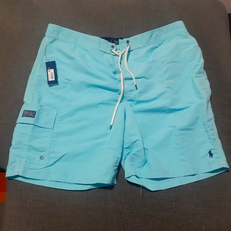 This Item Is In Wonderful Condition. Light Blue Beachwear Shorts, Light Blue Short Swimwear For Beach, Short Light Blue Swimwear For The Beach, Fitted Blue Shorts For Pool, Blue Fitted Shorts For Pool, Light Blue Beachwear Shorts For Beach Season, Blue Tight-fitting Shorts For The Pool, Blue Nylon Shorts For Vacation, Light Blue Casual Short Swimwear