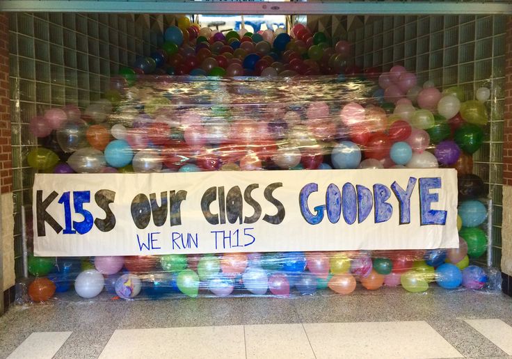 there is a sign that says kids out class goodbye we run this in front of some balloons