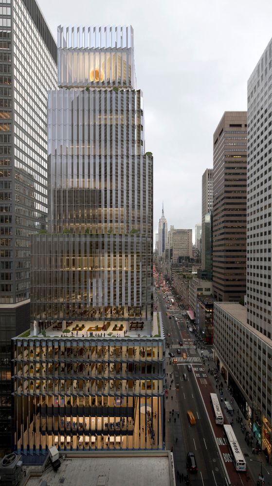 an aerial view of skyscrapers in the city with cars and buses driving on the street