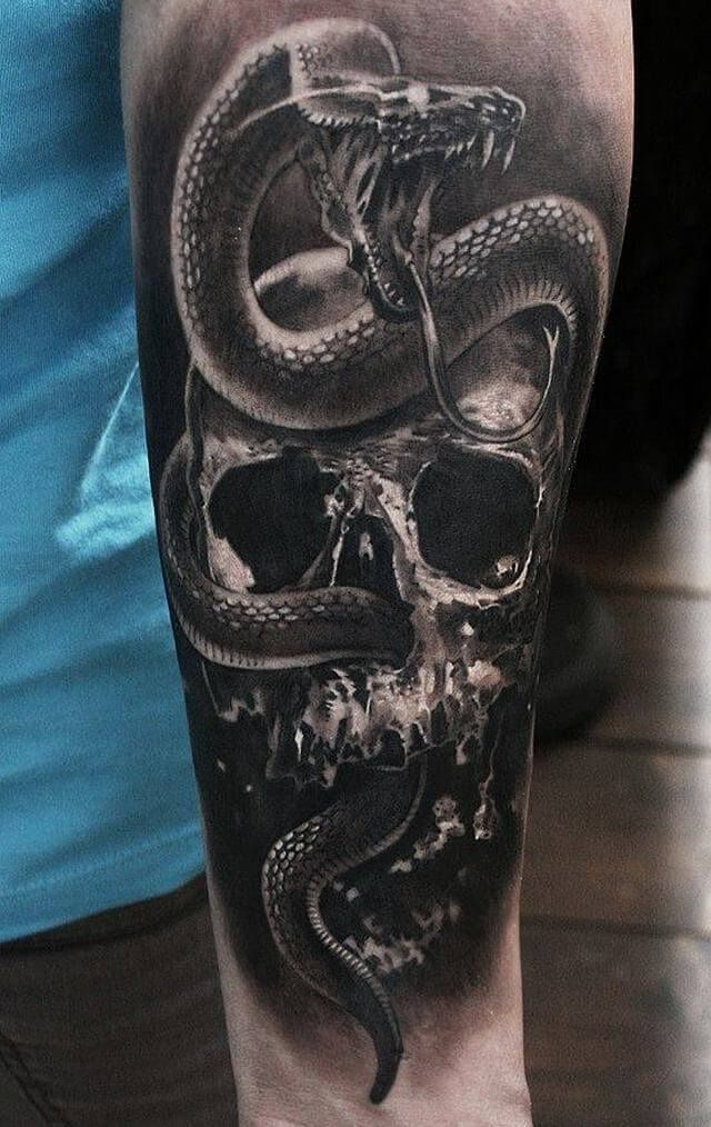 a man's arm with a skull and snake tattoo on it