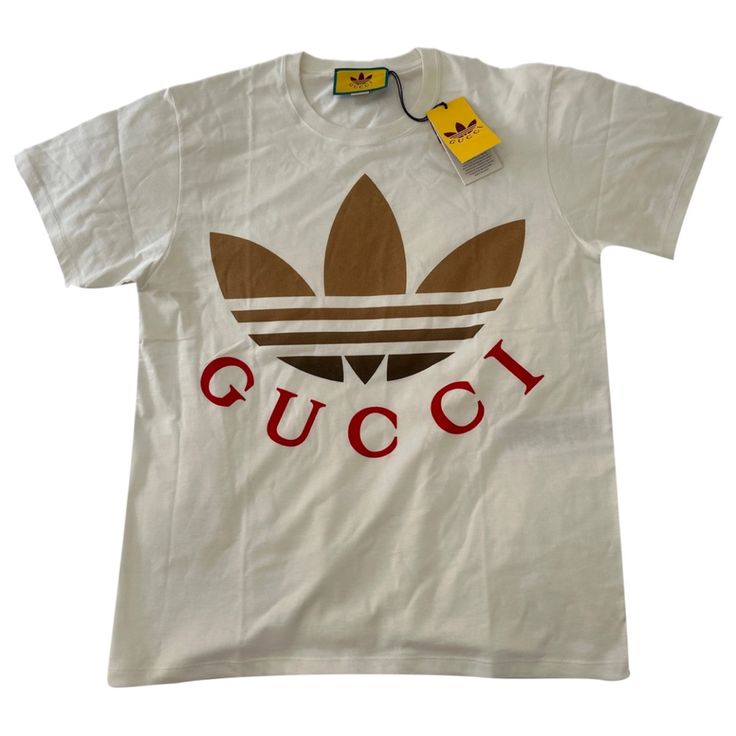 New Gucci Adidas Oversize T Shirt Never Worn With Tags Beautiful And Ready For The Summer Price Is Firm Nothing Lower Will I Except Trendy White Top With Logo, Casual Cotton Tops With Designer Logo, Casual Designer Logo Tops For Streetwear, Casual Tops With Designer Logo For Streetwear, Casual Crew Neck Top With Designer Logo, Casual Summer Tops With Designer Logo, White Monogram Print Top For Streetwear, Designer White Tops With Graphic Print, Gucci Short Sleeve Shirt For Summer