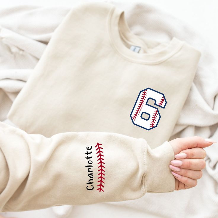 Custom  Baseball Sweatshirt, Custom Baseball Mom Sweatshirt, Custom Name and Number Baseball Sweater, Baseball Season, Baseball Mom Welcome to our cozy corner of comfort and style! We are thrilled to have you here at CozzyBoutigue, where every thread is woven with care and warmth. PRODUCT DETAILS Collar, shoulders, armholes, cuffs and hem double-needle stitched - 1 x 1 rib with spandex Features a crewneck - Relaxed fit - Unisex - 50% cotton 50% polyester HOW TO ORDER 1- Please review all photos, Baseball Mom Sweater, Long Sleeve T-shirt For Baseball Game Day, Long Sleeve T-shirt For Baseball Season, Baseball Season Fan Apparel Long Sleeve Sweatshirt, Team Name Long Sleeve T-shirt For Baseball Season, Cotton Baseball Season Sports Sweatshirt, Long Sleeve T-shirt For Baseball Season Game Day, Collegiate Cotton Sweater For Sports, Cotton Sweatshirt For Baseball Season Sports