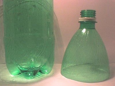 two green glass bottles sitting next to each other