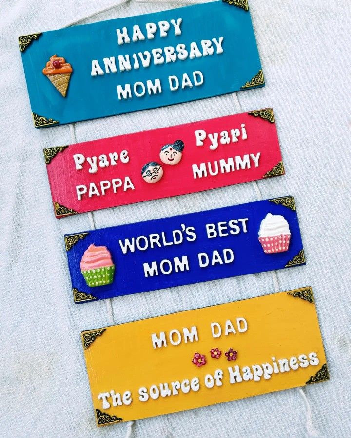 four wooden signs that say happy anniversary, happy mom, happy dad and happy birthday