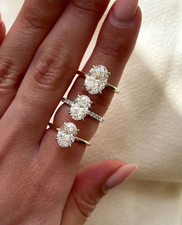 three diamond rings on the finger of a woman