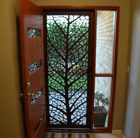 an entry door with decorative glass panels on it