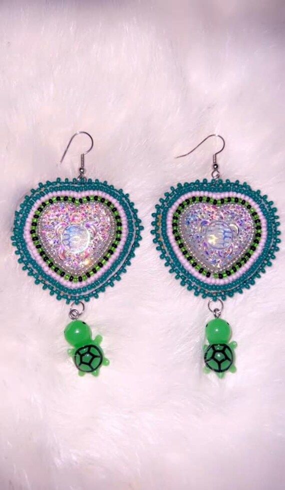 hand made by me! im a first nations artist who is 21 years old just trying to share my passion for beading and my culture! only one pair available but more to come Handmade Unique Beaded Earrings With Round Beads, Unique Handmade Beaded Drop Earrings, Bohemian Beaded Earrings With Heart Beads For Gift, Unique Beaded Earrings For Festivals, Bohemian Earrings With Heart Beads For Festivals, Bohemian Heart Beads Earrings For Festival, Bohemian Beaded Heart Drop Earrings, Bohemian Festival Earrings With Heart Beads, Bohemian Heart Beads Drop Earrings