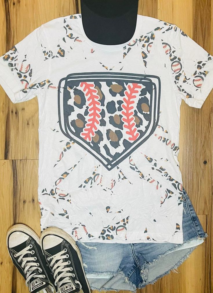 an image of a baseball t - shirt and denim shorts on a wooden floor with sneakers