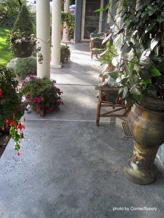 an outdoor patio area with potted plants and chairs