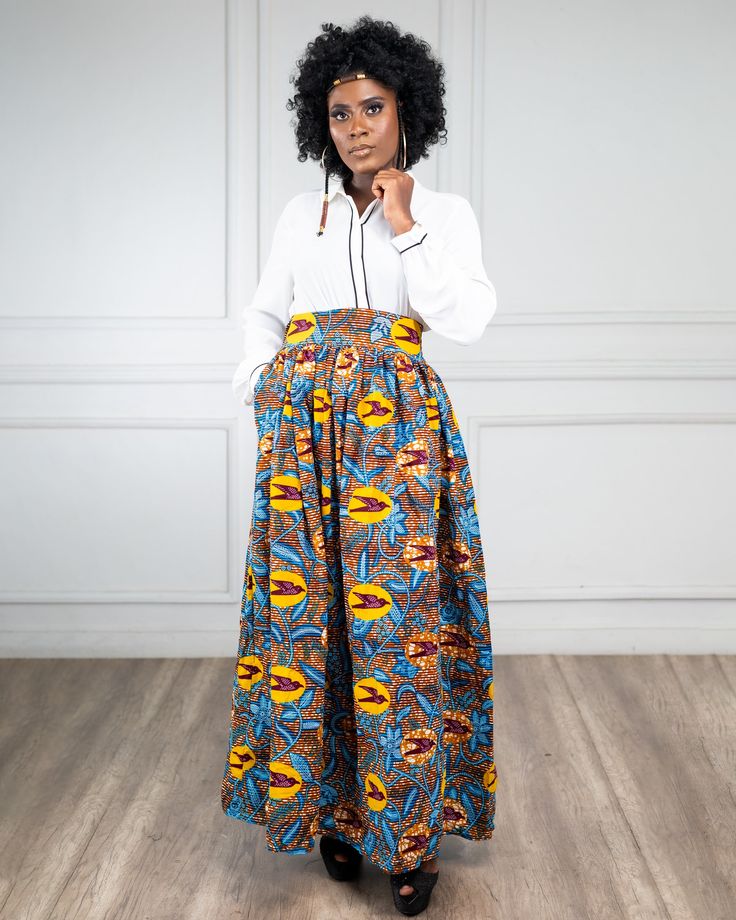 This beautiful skirt is made with 100% African print fabric. it measures 43 inches  long.It has elastic  and a zipper on the back . This skirt is high  waist and fits better when  the band is under your bust.   .############################################################################################################################################################  COLD WASH ONLY. SASH side pocket  Zip Closure Elastic CARE INSTRUCTIONS:  Dry Clean Recommended DO NOT BLEACH Press with warm iron  Cold wash only Size ChartInches Size XS (US S 0-2) 24-25 Size S (US S 4-6) 28-30 Size M (US S 8-10) 31-33 Size L (US 12-14) 34-36 Size XL (US 14-16) 36-38 Size XXL (US 16-18) 38-40 Size 3XL(US 18-22) 40 - 45 Multicolor Flowy High Waist Maxi Skirt, High Waist Floral Print Maxi Skirt, High Waist Relaxed Floral Maxi Skirt, High Waist Floral Print Maxi Skirt In Relaxed Fit, Printed Relaxed Fit Maxi Skirt, Printed Maxi Length Flowy Skirt, Printed Flowy Maxi Skirt, Beautiful Skirt, African Print Fabric