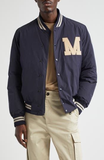 The label renowned for its outerwear draws inspiration from classic varsity aesthetics with a bomber detailed with striped edges and a leather logo appliqué. Front snap closure Blade collar Front welt pockets Ribbed cuffs and hem Lined 100% polyester with leather contrast Hand wash, line dry Imported Designer Clothing Winter College Varsity Jacket With Logo Detail, College Varsity Jacket With Logo For Winter, Winter Varsity Jacket With Logo Detail, Winter Varsity Jacket With Logo And Baseball Collar, Varsity Outerwear With Logo Detail And Baseball Collar, Varsity Outerwear With Baseball Collar And Logo Detail, Casual Winter Varsity Jacket With Logo Detail, Sporty Varsity Jacket With Logo Detail For Winter, Casual Varsity Jacket With Logo And Baseball Collar