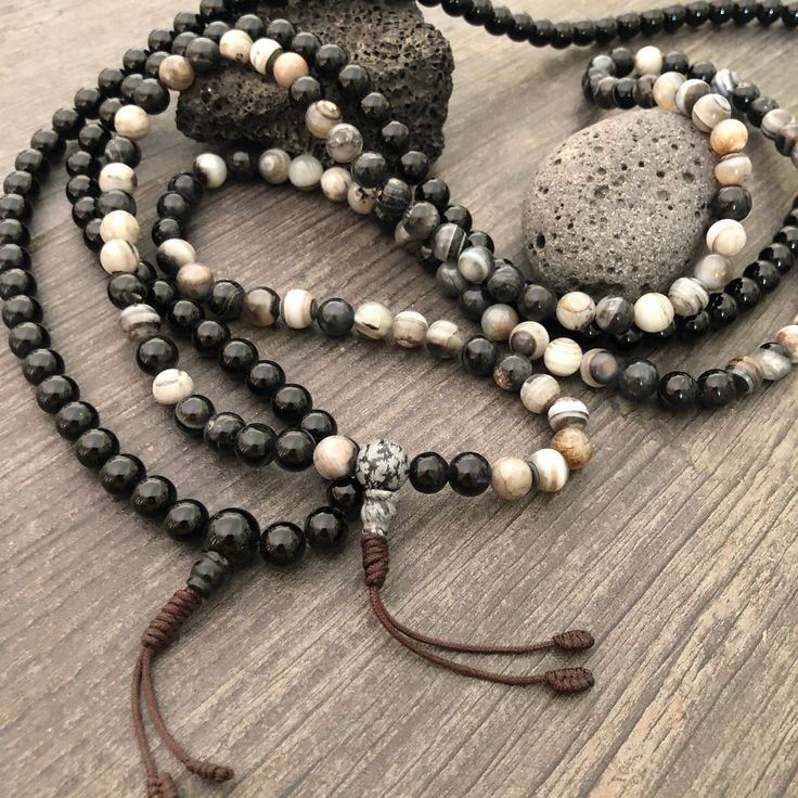 Beautiful black and mix Agate Japa Mala from Nepal. You can choose between the Black Agate mala and the Mix Agate mala necklace. A unique praying mala that can be used as a necklace or as an ornament. The mala has no clasp, you wear it over the head. The mala necklace is 42.5cm- 16.75 inch long A most have addition to your jewelry collect To see more unique Mala necklaces click the link below https://www.etsy.com/shop/AkashiJewelry?ref=seller-platform-mcnav&section_id=18307945 Enjoy Con salu Agate Beaded Bracelets With 108 Beads For Meditation, Black Beaded Bracelet With 108 Beads For Meditation, Black Spiritual Healing Beads, Spiritual Black Beaded Necklaces For Meditation, Spiritual Black Beaded Necklaces, Meditation Onyx Beaded Bracelets, Meditation Onyx Beaded Bracelets With Round Beads, Adjustable Agate Hand-strung Mala, Adjustable Hand-strung Agate Mala