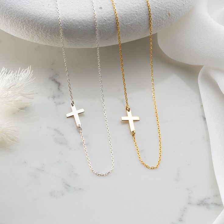 Introducing our Handmade Gold Sideways Dainty Cross Necklace, a gracefully designed piece that adds a touch of elegance to your style. Meticulously crafted in two exceptional material options: 925 sterling silver and 14K solid gold, this necklace offers a choice between classic sophistication and the enduring warmth of gold. While the choice of materials is significant, what truly sets this necklace apart is the delicate sideways placement of the cross, symbolizing faith and spirituality. Whether you opt for the timeless allure of gold or the classic beauty of silver, this necklace is more than jewelry; it's a personal expression of belief, a subtle yet powerful connection to your faith. Both materials, sterling silver and 14K solid gold, are of the highest quality, ensuring that your choi Elegant Adjustable Cross Necklace With Clavicle Chain, Silver Necklace With Delicate Chain And Cross Pendant, Elegant Adjustable Clavicle Chain Cross Necklace, Gift Clavicle Chain Necklace With Cross Pendant, Wedding Clavicle Chain Necklace With Cross Shape, Silver Cross Necklace With Delicate Chain For Gift, Adjustable Cross Necklace With Delicate Chain, Wedding Cross Necklace With Clavicle Chain, Minimalist Cross Necklace For Jewelry Making