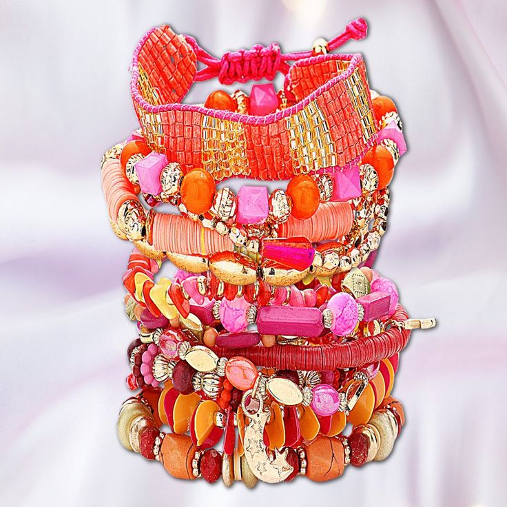 Part Of Our New Signature Stack Collection Of Artisan Beaded Stretch Boho Bracelet Sets. This Super-Sized Set Features Shades Of Coral, Pink, Magenta, Gold, Amber & Orange. Picture Witnessing A Stunning Sunset Seemingly Rising From The Sands Of The Sahara. There Are 14 Gorgeous Beaded Stretch Bracelets And 1 Seed Beaded Pull-To-Fit Tassel Back Bracelet For A Total Of 15 Pcs. The Gold-Dipped Charms Include Feathers, Cactus, Crescent Moon & Geometric Shapes. All Items From Our Own Artisan Line Of Pink Beaded Bracelets For Vacation, Pink Beaded Bracelet For Vacation, Pink Beaded Friendship Bracelets For Summer, Summer Beaded Pink Friendship Bracelets, Summer Pink Beaded Friendship Bracelets, Pink Round Beads Friendship Bracelets For Vacation, Hand-strung Pink Jewelry For Summer, Hand-strung Pink Summer Jewelry, Pink Hand-strung Summer Jewelry