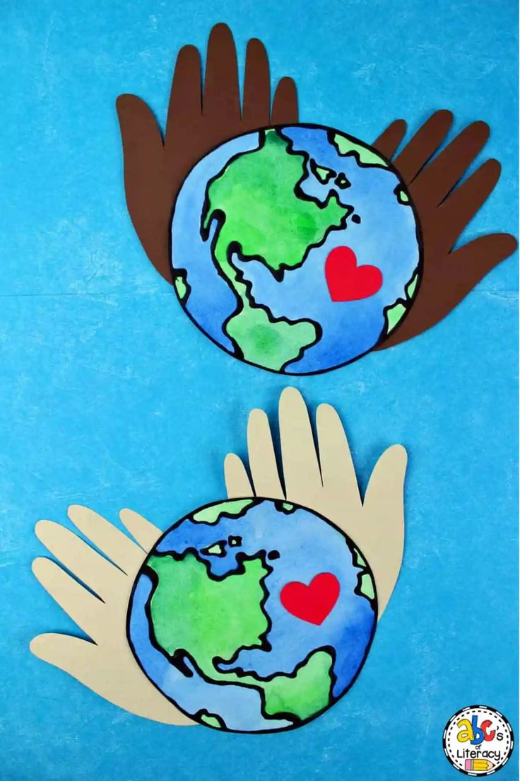 two hands are holding the earth with hearts on it, and one hand is wearing gloves