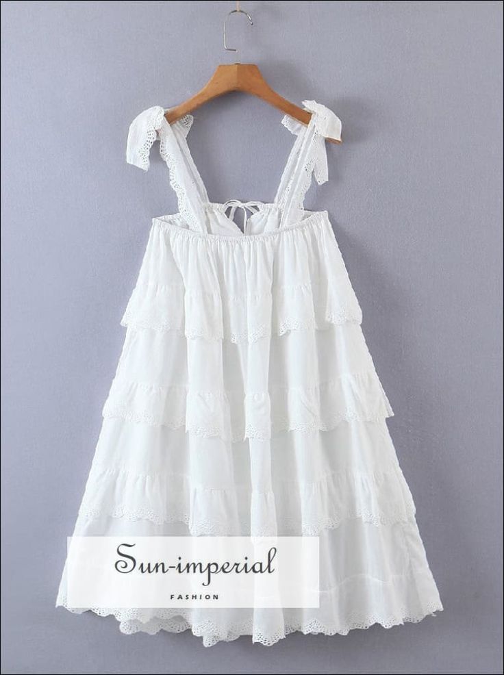 Women White Layered Lace Ruffles Puff Mini Dress with Tie Cami Strap and Center Details Sun-Imperial United States White Suspender Dress With Straps For Spring, Sleeveless Ruffled Suspender Dress For Vacation, Sleeveless Ruffles Suspender Dress For Vacation, White Spring Suspender Dress With Spaghetti Straps, White Suspender Dress With Spaghetti Straps For Spring, Bohemian Dresses With Straps, White Sling Sundress, White Ruffled Suspender Dress For Spring, Ruffled Maxi Dress With Spaghetti Straps For Brunch