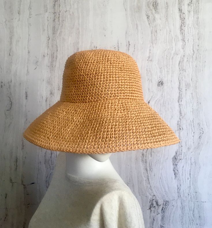 Crochet raffia hat     It is a classic accessory for every woman for sun protection, summer parties, beach and travel. It can be a good gift for a woman of any age. The hat is crocheted of natural raffia, light, elastic, the brim of the hat is reinforced with wire. The hat keeps its shape well and does not fade in the sun. The hat is soft to the touch, slightly rough. It is completely crocheted by hand. Easy to carry thanks to the foldable design. The hat matches perfectly with a summer wardrobe. Color: Straw color Size: 21 1/2 - 23 1/2 inches Field size: about 4 inches Care of the product:        It is better to dry the hat naturally, without using additional heating sources. When the raffia product dries, it returns to its original shape.        You cannot wash them in the usual way. If Elegant Handmade Panama Hat For The Beach, Elegant Handmade Panama Hat For Beach, Elegant Vacation Straw Hat Made Of Paper Straw, Uv Protection Brimmed Panama Hat, Elegant Paper Straw Hat For Vacation, Chic Brimmed Straw Bucket Hat, Handmade Straw Hat For Spring Vacation, Chic Straw Brimmed Bucket Hat, Straw Crochet Hat For Warm Weather